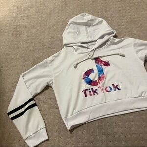 TikTok white long sleeve logo hoodie. Black stripes on arm.